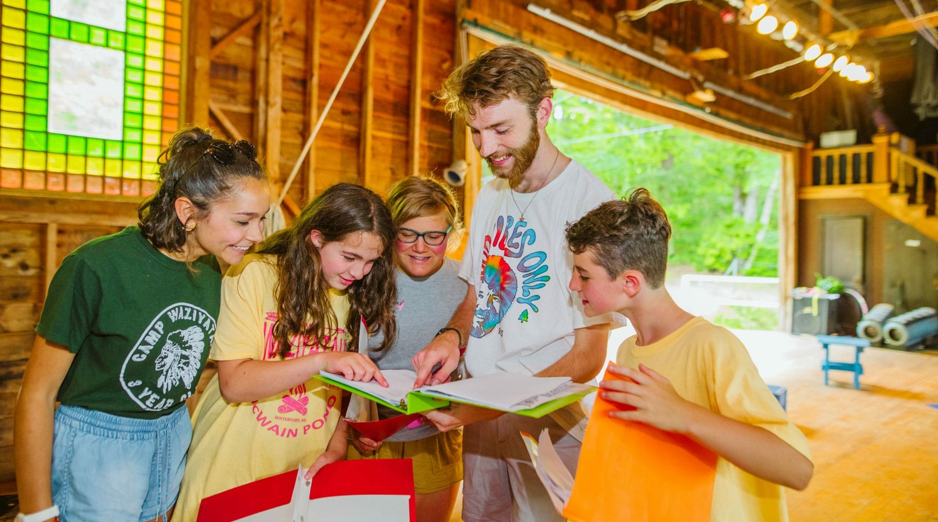 Staff and campers reading a script for acting