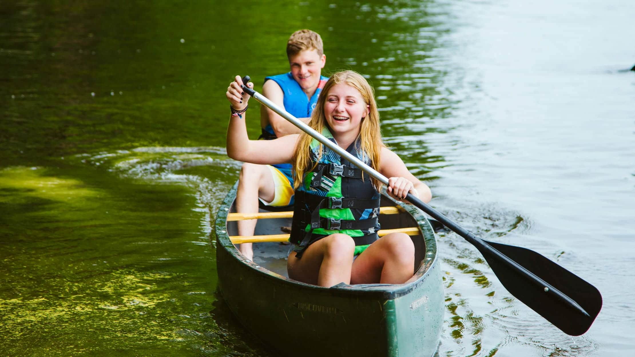 Two campers canoeing on a lake