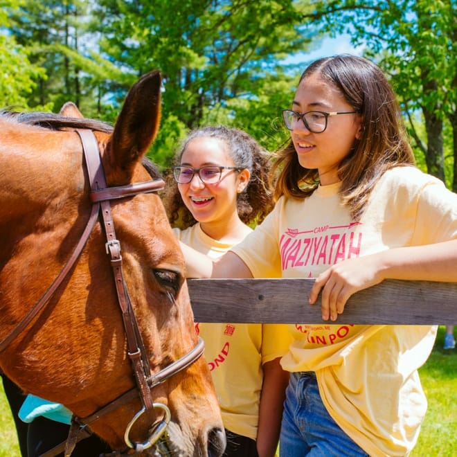 Girls petting a horse at Wazi