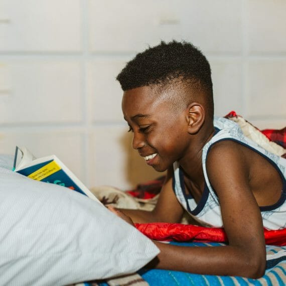 Boy reading in his Wazi cabin