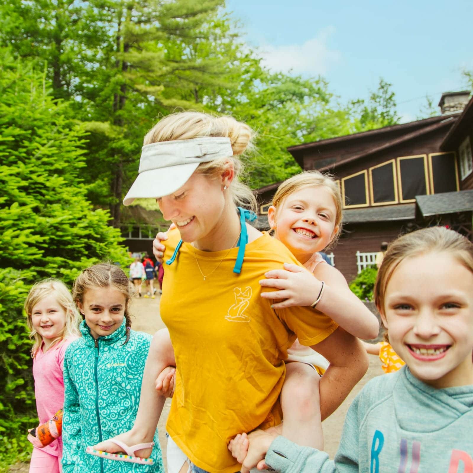 Staff giving a piggyback ride to campers