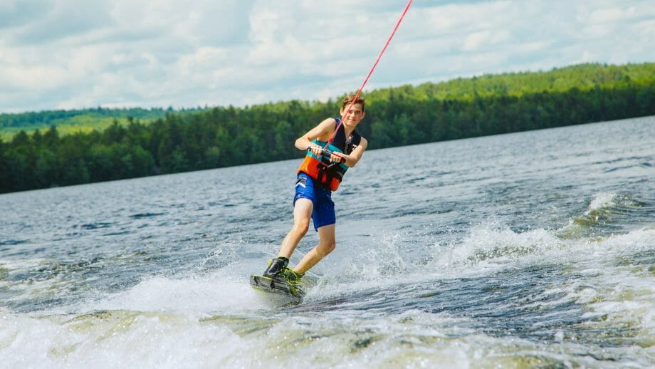Boy wakeboarding on the lake