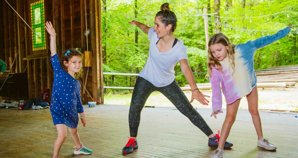 Dance instructor teaching campers dance moves