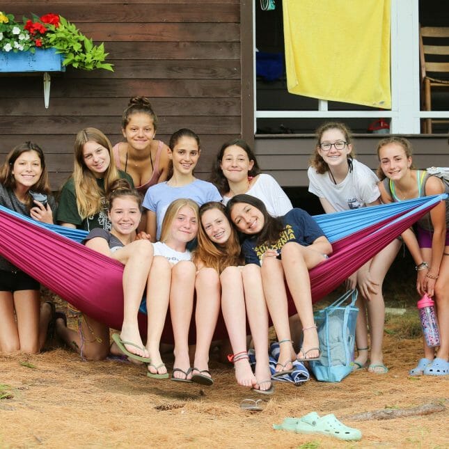 Girls on a hammock by their Wazi cabin