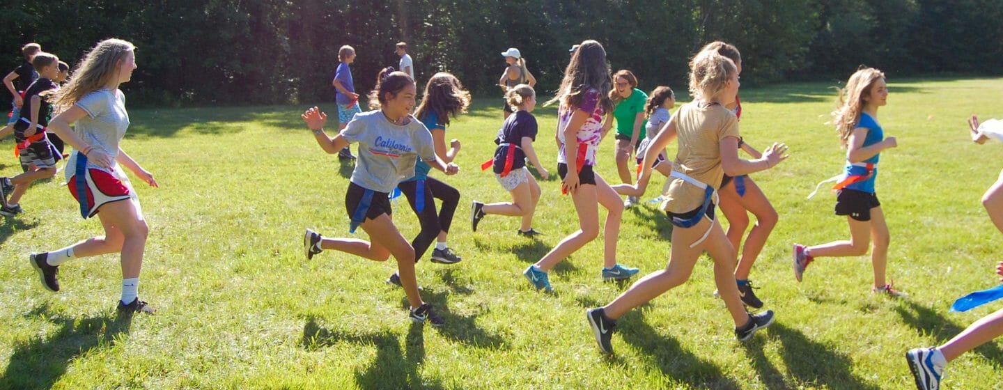 Girls running during flag football game