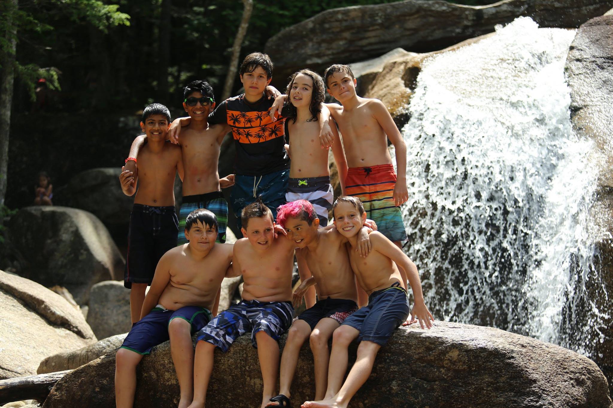 Boys in front of waterfall